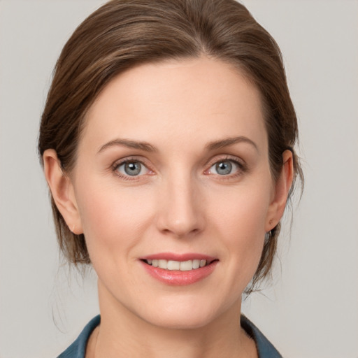 Joyful white young-adult female with medium  brown hair and blue eyes