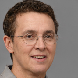 Joyful white middle-aged male with short  brown hair and brown eyes