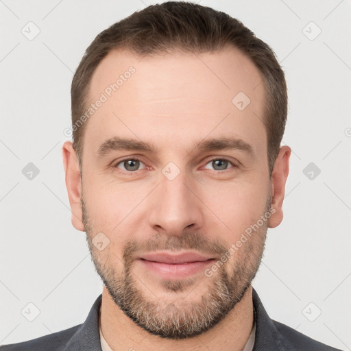 Joyful white young-adult male with short  brown hair and grey eyes