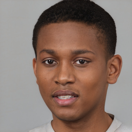 Joyful black young-adult male with short  brown hair and brown eyes