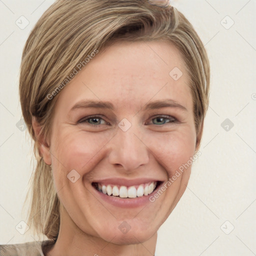 Joyful white young-adult female with medium  brown hair and grey eyes