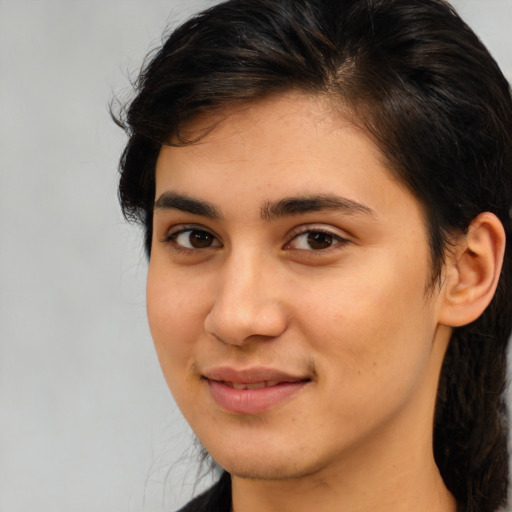 Joyful latino young-adult female with medium  brown hair and brown eyes