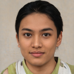 Joyful latino young-adult female with short  black hair and brown eyes