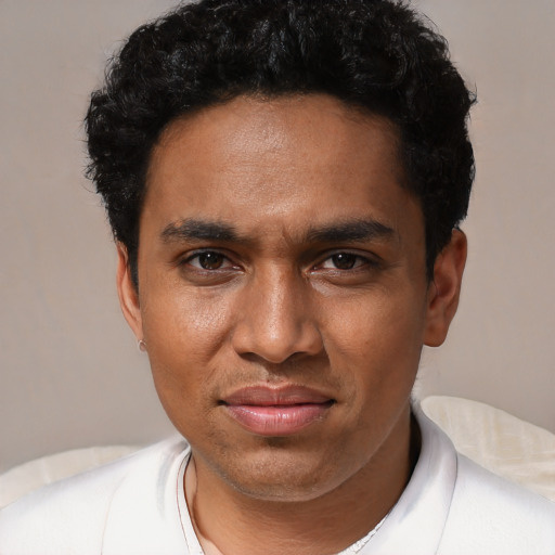 Joyful black young-adult male with short  black hair and brown eyes