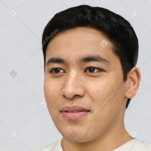 Joyful asian young-adult male with short  black hair and brown eyes