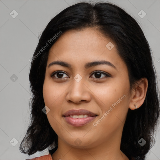 Joyful latino young-adult female with medium  brown hair and brown eyes