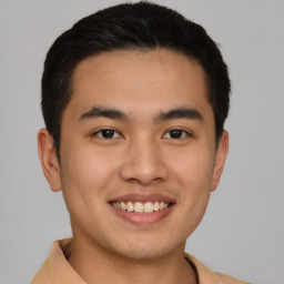 Joyful latino young-adult male with short  brown hair and brown eyes