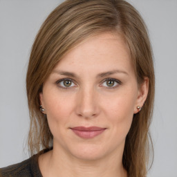 Joyful white young-adult female with medium  brown hair and green eyes