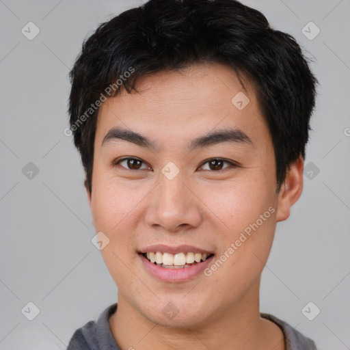 Joyful asian young-adult male with short  brown hair and brown eyes