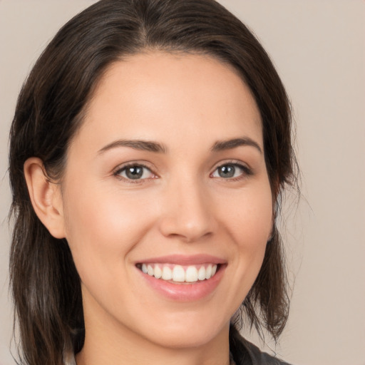 Joyful white young-adult female with medium  brown hair and brown eyes