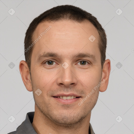 Joyful white young-adult male with short  brown hair and grey eyes