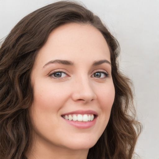 Joyful white young-adult female with long  brown hair and green eyes