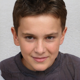 Joyful white child male with short  brown hair and brown eyes