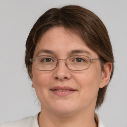 Joyful white adult female with medium  brown hair and grey eyes