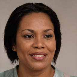 Joyful black adult female with medium  brown hair and brown eyes