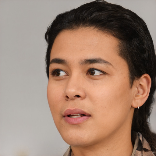Joyful asian young-adult male with medium  black hair and brown eyes