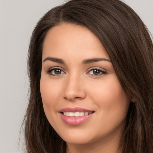 Joyful white young-adult female with long  brown hair and brown eyes