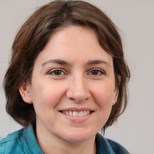 Joyful white adult female with medium  brown hair and grey eyes