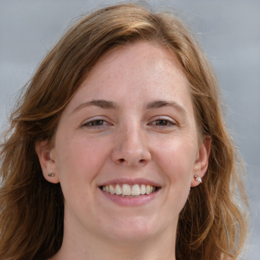 Joyful white young-adult female with medium  brown hair and blue eyes