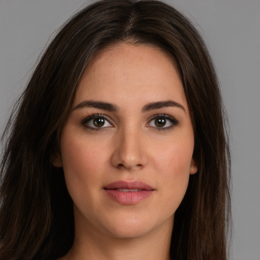 Joyful white young-adult female with long  brown hair and brown eyes