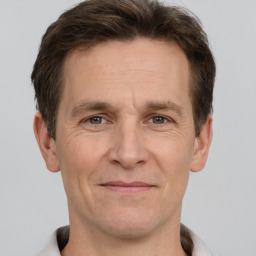 Joyful white adult male with short  brown hair and grey eyes