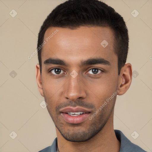 Joyful white young-adult male with short  black hair and brown eyes