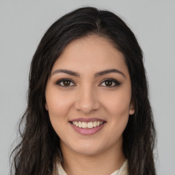 Joyful latino young-adult female with long  brown hair and brown eyes