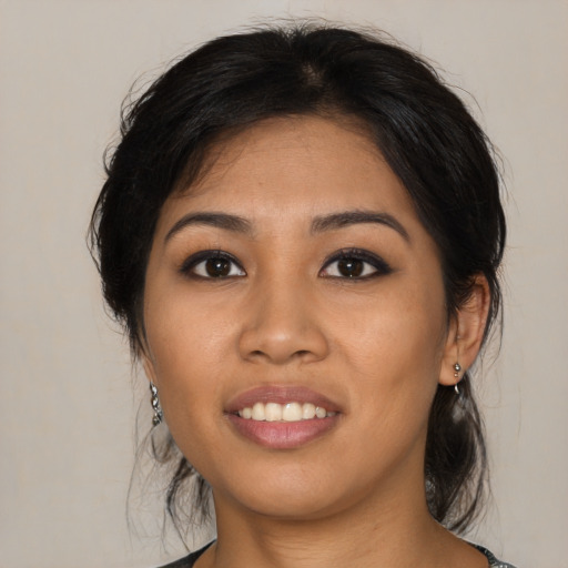 Joyful asian young-adult female with medium  black hair and brown eyes