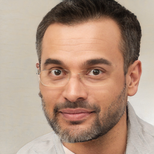 Joyful white adult male with short  brown hair and brown eyes