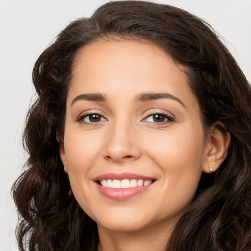 Joyful white young-adult female with long  brown hair and brown eyes