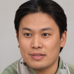 Joyful asian young-adult male with short  brown hair and brown eyes