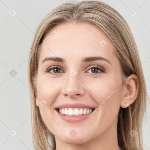 Joyful white young-adult female with long  brown hair and blue eyes