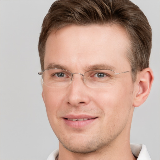 Joyful white adult male with short  brown hair and grey eyes