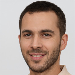 Joyful white young-adult male with short  brown hair and brown eyes