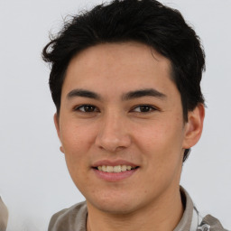 Joyful asian young-adult male with short  brown hair and brown eyes