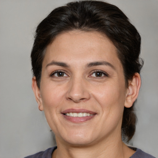 Joyful white adult female with medium  brown hair and brown eyes