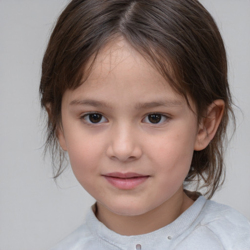 Joyful white child female with medium  brown hair and brown eyes