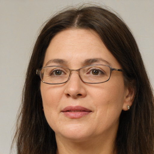 Joyful white adult female with long  brown hair and brown eyes