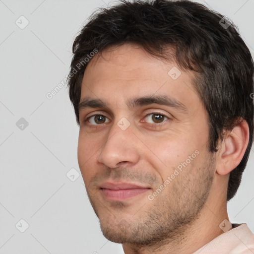 Joyful white adult male with short  brown hair and brown eyes