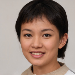 Joyful asian young-adult female with medium  brown hair and brown eyes