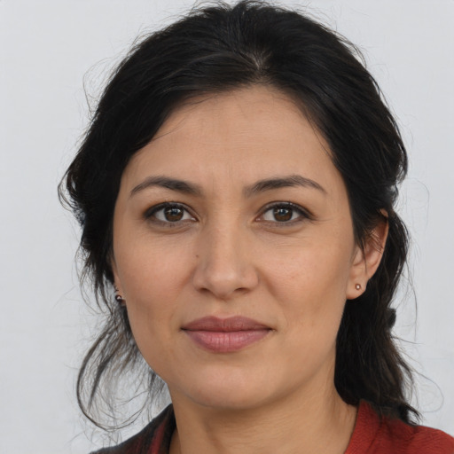 Joyful latino young-adult female with medium  brown hair and brown eyes
