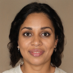 Joyful black adult female with medium  brown hair and brown eyes