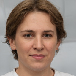 Joyful white adult female with medium  brown hair and brown eyes