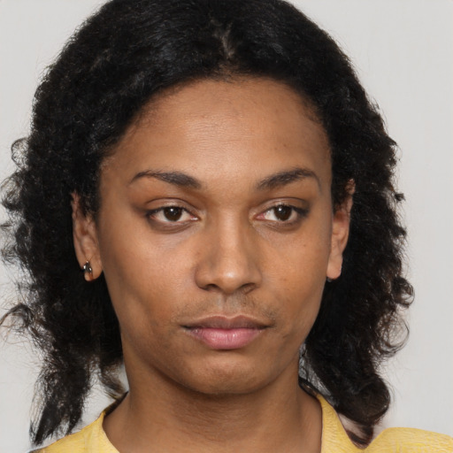 Neutral black young-adult female with medium  brown hair and brown eyes