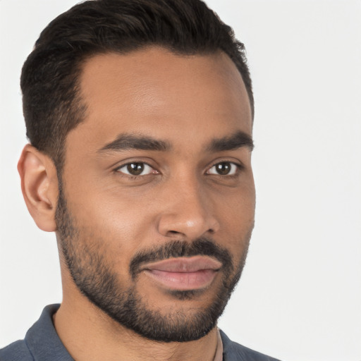 Joyful latino young-adult male with short  black hair and brown eyes