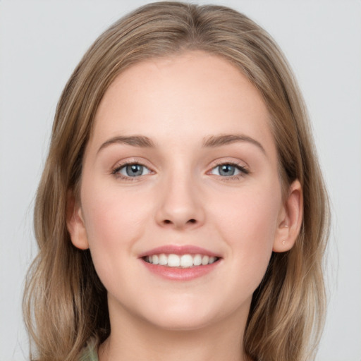 Joyful white young-adult female with long  brown hair and grey eyes