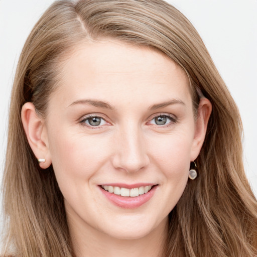 Joyful white young-adult female with long  brown hair and blue eyes