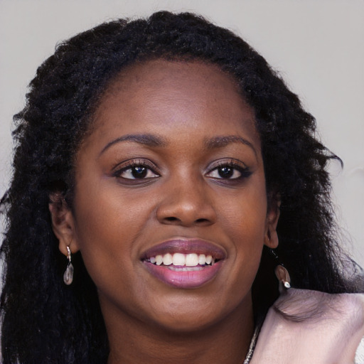 Joyful black young-adult female with long  brown hair and brown eyes