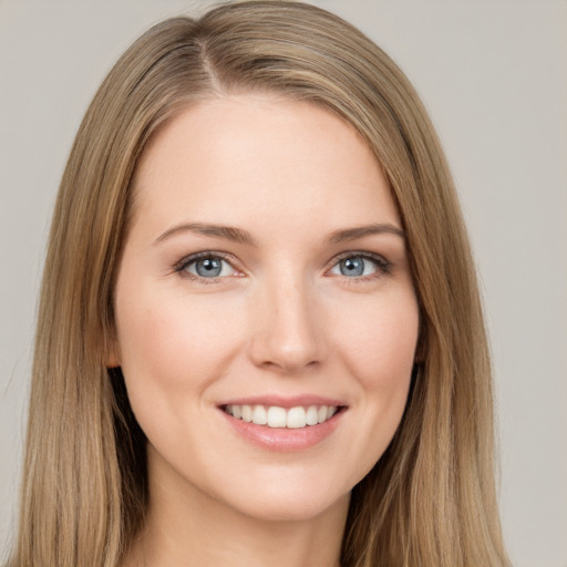 Joyful white young-adult female with long  brown hair and grey eyes