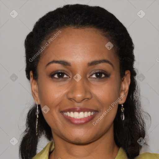 Joyful black young-adult female with long  black hair and brown eyes